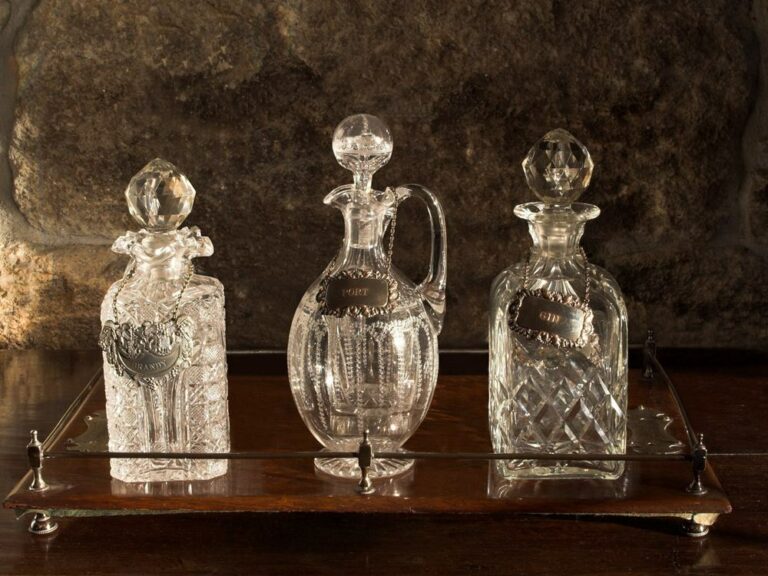 Various Antique Glass Decanters On Wooden Tray