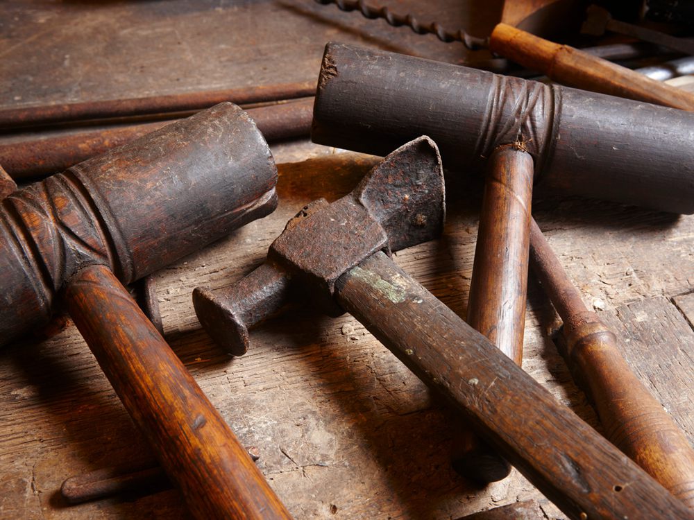 Antique tools. Hammers with wood pieces.